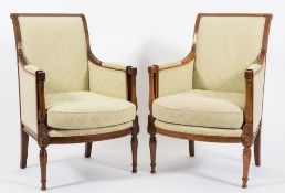 A pair of early 19th Century French beechwood fauteuils:, with rectangular upholstered panel backs,