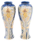 A pair of Macintyre (Moorcroft) Florian Ware vases: of slender baluster form tube lined in the Iris