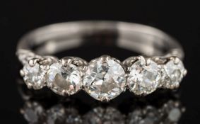 A white metal and diamond five-stone ring: with graduated circular,