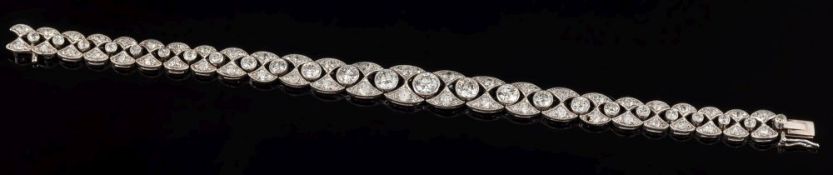 An early 20th century platinum and diamond bracelet: of graduated links, 7mm wide to 10mm wide,