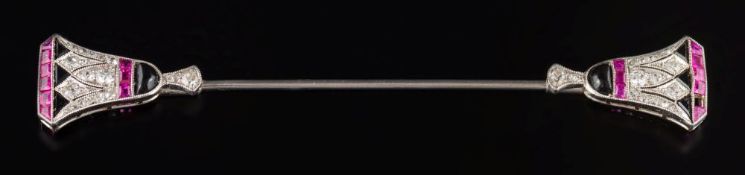 An Art Deco black onyx, diamond and ruby jabot pin: with stylised Egyptian lily terminal motifs,