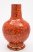 A Chinese 'faux bois' porcelain bottle vase: painted to imitate wood grain on a coral ground,