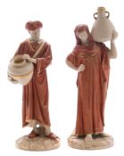 A pair of Royal Worcester figures of male and female Eastern water carriers: modelled by James