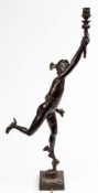 After Giambologna, a bronze study of Mercury: holding a torch aloft, on a square base,