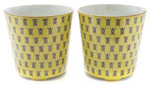 A pair of Chinese yellow ground 'longevity' jardinieres: of flared cylindrical form with ruyi head