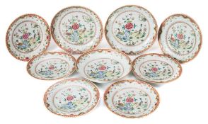 A set of three Chinese famille rose deep dishes and six matching plates: painted with peacocks,