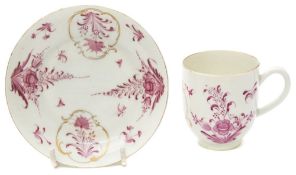 A First Period Worcester coffee cup and saucer: painted in puce camaieu in the Meissen manner with