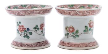 A pair of Chinese famille verte trencher pounce pots or sanders: painted with floral sprays and