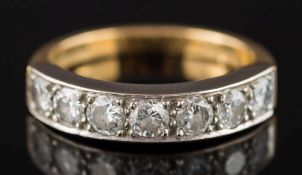 An 18ct gold and diamond seven-stone half-eternity ring: with circular brilliant-cut diamonds