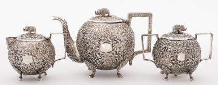 An Indian silver three-piece tea service: of circular form with all over foliate decoration with