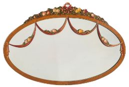 A satinwood and decorated oval mirror:, with simulated ivory and ebonised lines,