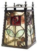 An Art Nouveau coppered metal hall lantern: the leaded coloured glass panels with flower head and