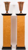 A pair of Art Deco burr maple veneered and ebonised square pedestals: raised on stepped plinth