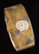 A lady's 18ct gold three-colour 'Longines' wristwatch: the integrated circular dial with Arabic