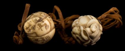 Two Japanese carved ivory ojime beads on leather cord and an okimono of a samurai: one ojime carved