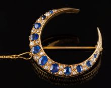 A late 19th century gold, sapphire and diamond crescent brooch: with graduated,