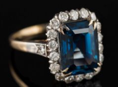 A sapphire and diamond cluster ring: the octagonal sapphire approximately 10.7mm long x 8.