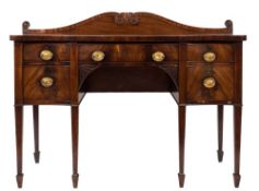 A George III mahogany sideboard:, of serpentine outline,