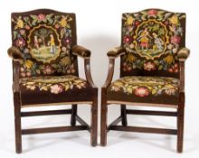 A pair of mahogany library open armchairs of Gainsborough type in the Chippendale taste:,