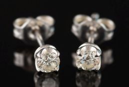 A pair of diamond single-stone ear studs: approximately 0.