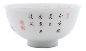 A Chinese porcelain bowl: of finely potted circular form with everted rim enamelled in the famille
