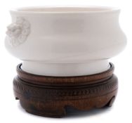 A Chinese Dehua porcelain censer: of squat rounded form with Buddhist lion head handles,