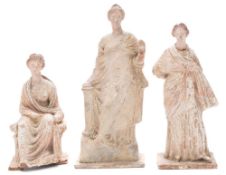 Three Tanagra (Boetian) hollow cast groups: comprising one seated and two standing classically