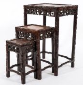 A nest of three (of four) Chinese carved hardwood occasional tables:,