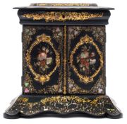 A Victorian black lacquered papier mache sewing cabinet: the hinged lid enclosing compartments