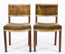 A pair of King George VI Coronation oak chairs:, with curved upholstered backs with G.R.