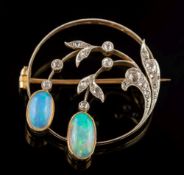 An opal and diamond circular brooch: mille-grain set with graduated,