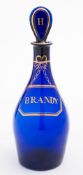 A 'Bristol' blue glass decanter and matched stopper: of mallet shaped form decorated in gold with a