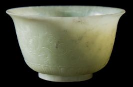 A Chinese carved celadon jade bowl: with flared rim and short cylindrical footrim,