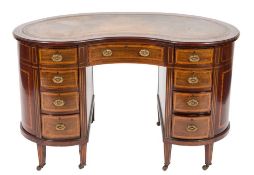 An Edwardian mahogany, satinwood crossbanded and inlaid kneehole desk:, of kidney shaped outline,