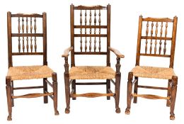 A harlequin set of eight early 19th Century elm and ash spindle back dining chairs,