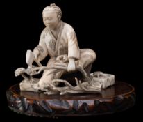 A Japanese carved and stained ivory okimono, signed ...........