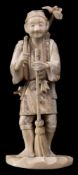 A Japanese carved ivory okimono, signed Gyokushi: of a smiling peasant holding a besum broom,