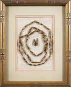 A Victorian rolled paper necklace: of lozenge design, spaced with glass beads, mounted and framed.