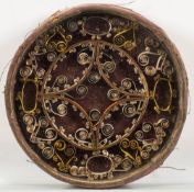 An early 19th century quillwork decorated panel: of circular outline with scroll ,