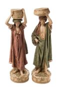 A pair of Royal Dux Bohemia (Edward Eichler) porcelain figures: each modelled standing bare footed