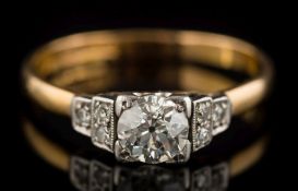 An 18ct gold, platinum and diamond solitaire ring: the circular, old-cut diamond 5.4mm diameter x 3.