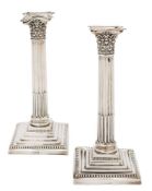 A matched pair of Edward VII silver Corinthian column candlesticks, maker Walter Latham & Sons,