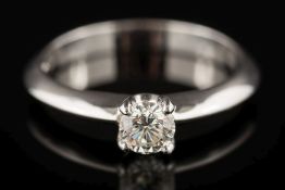 An 18ct white gold and diamond solitaire ring: the circular,