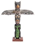 A native North American polychrome decorated small totem pole: carved with mythical beats and