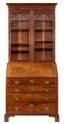 A George III mahogany bureau bookcase:, the upper part with a moulded cornice,