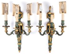 A pair of Louis XVI-style painted and gilt brass wall brackets: the tapering back plates surmounted