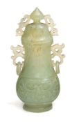 A Chinese carved celadon jade archaistic two-handled vase and cover: of flattened baluster form,