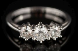 A graduated diamond three-stone ring: with circular,