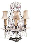 A bronzed metal three-branch candelabra: the harp-shaped open back hung with prismatic glass drops