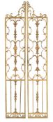 A pair of carved giltwood and gesso screen panels:, with shaped scroll surmounts,